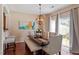 Stylish dining area with a unique light fixture, bar stool seating, and natural lighting at 5204 Nautical Ln, Raleigh, NC 27610