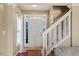 Bright entryway features a staircase, a front door with windows, and hardwood floors at 5204 Nautical Ln, Raleigh, NC 27610