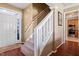 Entryway with staircase featuring carpeted steps and hardwood floors, leading to the upper level at 5204 Nautical Ln, Raleigh, NC 27610