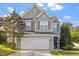 Charming two-story home featuring a well-manicured lawn and attached two-car garage at 5204 Nautical Ln, Raleigh, NC 27610