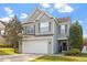 Traditional two-story home boasts a well-maintained lawn and an attached two-car garage at 5204 Nautical Ln, Raleigh, NC 27610