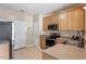 Functional kitchen equipped with stainless steel appliances, wood cabinets, and a practical layout at 5204 Nautical Ln, Raleigh, NC 27610
