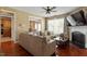 Comfortable living room showcases a stylish fireplace, a large sectional, and seamless flow to the dining area at 5204 Nautical Ln, Raleigh, NC 27610
