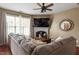 Relaxing living room with fireplace, large sofa, and a large window for natural light at 5204 Nautical Ln, Raleigh, NC 27610