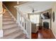 Inviting living room with a cozy fireplace and staircase leading to the upper level at 5204 Nautical Ln, Raleigh, NC 27610