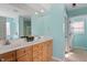 Bright main bathroom with double sinks, tile floors, and modern finishes at 5204 Nautical Ln, Raleigh, NC 27610