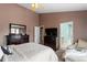 Comfortable main bedroom with neutral carpet, ceiling fan, and furnishings at 5204 Nautical Ln, Raleigh, NC 27610