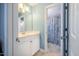 Bright bathroom with white cabinets, toilet, and shower with blue patterned curtain at 5515 S Roxboro St # 23, Durham, NC 27713