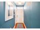 Welcoming blue entryway features a white front door and warm hardwood flooring at 5515 S Roxboro St # 23, Durham, NC 27713