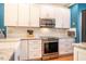 Modern kitchen boasts stainless steel appliances, white cabinets, and granite countertops at 5515 S Roxboro St # 23, Durham, NC 27713
