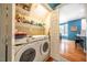 Bright laundry room with washer, dryer, shelving and access to the breakfast nook at 5515 S Roxboro St # 23, Durham, NC 27713