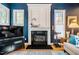 Inviting living room featuring a fireplace, hardwood floors, and large windows at 5515 S Roxboro St # 23, Durham, NC 27713