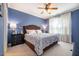 Comfortable bedroom with a ceiling fan, bedside tables, and soft lighting at 5515 S Roxboro St # 23, Durham, NC 27713