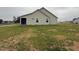 Exterior view of home's backyard; grass, screen porch and vinyl siding at 56 Ruskin Dr, Smithfield, NC 27577