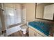 Functional bathroom featuring a shower-tub combo and a vanity with granite countertop and ample mirror at 56 Ruskin Dr, Smithfield, NC 27577
