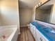Contemporary bathroom features a tub, a shower, and dual vanity with a bright modern mirror at 56 Ruskin Dr, Smithfield, NC 27577