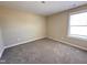Cozy bedroom with neutral walls, plush carpet, and a bright window, creating a comfortable space at 56 Ruskin Dr, Smithfield, NC 27577