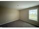 Neutral bedroom features plush carpeting, large window offering view of the outdoors at 56 Ruskin Dr, Smithfield, NC 27577
