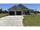 Beautiful new construction with a large, paved driveway and a well-maintained lawn at 56 Ruskin Dr, Smithfield, NC 27577