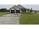 Charming home featuring a two-car garage, a covered porch, and a well-maintained lawn at 56 Ruskin Dr, Smithfield, NC 27577
