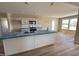 A well-lit kitchen with hardwood flooring, island, and modern stainless steel appliances at 56 Ruskin Dr, Smithfield, NC 27577