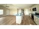 Kitchen island with stainless steel appliances, white cabinets, and an open floor plan at 56 Ruskin Dr, Smithfield, NC 27577