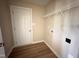 Practical laundry room featuring hardwood floors and ample space for appliances and storage at 56 Ruskin Dr, Smithfield, NC 27577