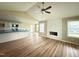 Bright living room with a fireplace, hardwood floors, and a view of the kitchen at 56 Ruskin Dr, Smithfield, NC 27577