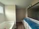 Main bathroom featuring a soaking tub, a vanity with plenty of storage, and a shower at 56 Ruskin Dr, Smithfield, NC 27577