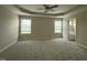 Spacious main bedroom with plush carpeting, large windows, and a tray ceiling at 56 Ruskin Dr, Smithfield, NC 27577