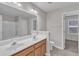 Bathroom with a double sink vanity, mirror, and tiled floor at 5609 Severn Grove Dr, Durham, NC 27703