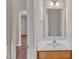 Bathroom with a single vanity, modern mirror, and clean, neutral decor at 5609 Severn Grove Dr, Durham, NC 27703