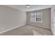 Bedroom with carpet flooring and large window, letting in natural light at 5609 Severn Grove Dr, Durham, NC 27703