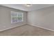 An empty room with carpeted flooring, neutral wall paint and bright natural light at 5609 Severn Grove Dr, Durham, NC 27703