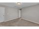 A simply designed room with carpet flooring, neutral wall paint, and two white doors at 5609 Severn Grove Dr, Durham, NC 27703