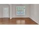 Bright living room with hardwood floors and a large window at 5609 Severn Grove Dr, Durham, NC 27703