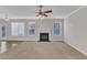 Open-concept living room with fireplace and access to the backyard through a glass door at 5609 Severn Grove Dr, Durham, NC 27703