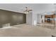 Open-concept living room with adjacent kitchen and dining space; carpeted, great natural light at 5609 Severn Grove Dr, Durham, NC 27703