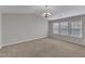 Bright, carpeted living room featuring a modern chandelier and large windows at 5609 Severn Grove Dr, Durham, NC 27703