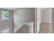 Well-lit stairwell with white railing, glass window and view of the entry way at 5609 Severn Grove Dr, Durham, NC 27703