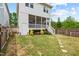 A spacious backyard featuring a well-maintained lawn, a screened-in porch, and a stepping stone pathway at 563 Great Ridge Parkway, Chapel Hill, NC 27516