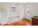 Welcoming entryway with hardwood floors, stairs, and natural light from the decorative front door at 563 Great Ridge Parkway, Chapel Hill, NC 27516