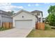 Attached 2-car garage with driveway and partial view of the backyard at 563 Great Ridge Parkway, Chapel Hill, NC 27516