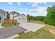 Detached garage with large driveway and partial view of the golf course at 563 Great Ridge Parkway, Chapel Hill, NC 27516