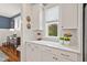 Bright kitchen area with white cabinetry, sleek countertops, and a view to an adjacent space with a buffet and artwork at 563 Great Ridge Parkway, Chapel Hill, NC 27516