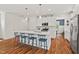 Spacious kitchen island with pendant lighting and bar stool seating provides a central gathering spot at 563 Great Ridge Parkway, Chapel Hill, NC 27516