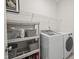 Functional laundry room with a washer, dryer, and plenty of storage shelves and baskets at 563 Great Ridge Parkway, Chapel Hill, NC 27516