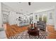 Bright, open living space showcasing the kitchen and seating area with hardwood floors and modern furnishings at 563 Great Ridge Parkway, Chapel Hill, NC 27516
