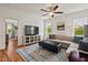 Inviting living room with hardwood floors, a comfy sectional, and natural light at 563 Great Ridge Parkway, Chapel Hill, NC 27516