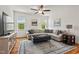 Bright living room showcasing hardwood floors, a ceiling fan, and a comfortable sectional sofa at 563 Great Ridge Parkway, Chapel Hill, NC 27516